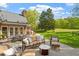Spacious stone patio features comfortable seating and dining areas with lush greenery and scenic views at 801 Pinehurst Dr, Chapel Hill, NC 27517