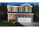 Charming two-story home boasting brick accents, lush landscaping, and a convenient two-car garage at 824 Ottawa Dr, Garner, NC 27529