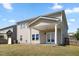 Backyard featuring a covered patio, swing set, and green lawn at 833 Ember Dr, Durham, NC 27703