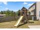 A backyard featuring a wooden playset, green grass, and privacy fence at 833 Ember Dr, Durham, NC 27703