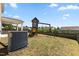 Lawn featuring a wooden playset with swings and slide in a fenced yard at 833 Ember Dr, Durham, NC 27703