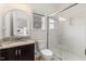 Bathroom features a dark vanity, granite countertop, modern lighting and shower at 833 Ember Dr, Durham, NC 27703