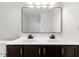 Bathroom features a dual sink vanity, large mirror, and a shower-tub combination at 833 Ember Dr, Durham, NC 27703