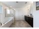 This bathroom features a large tub and a glass shower with granite countertops at 833 Ember Dr, Durham, NC 27703