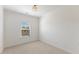 Bright bedroom with neutral carpet, a window with blinds, and a ceiling light at 833 Ember Dr, Durham, NC 27703