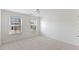 Carpeted bedroom featuring two windows and bright natural light at 833 Ember Dr, Durham, NC 27703