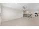 Bonus room includes carpet, a ceiling fan, and a staircase with decorative black rails at 833 Ember Dr, Durham, NC 27703