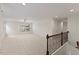 Spacious bonus room with plush carpet, a ceiling fan, and a decorative railing at 833 Ember Dr, Durham, NC 27703