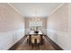 Formal dining room features decorative wallpaper, wainscoting, and a modern chandelier at 833 Ember Dr, Durham, NC 27703