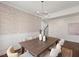 Elegant dining room with chandelier, decorative wallpaper, and views of the staircase at 833 Ember Dr, Durham, NC 27703