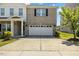 Charming two-story home featuring a brick facade, two-car garage, and manicured lawn at 833 Ember Dr, Durham, NC 27703