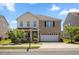 Charming two-story home featuring a brick facade, two-car garage, and well-maintained landscaping at 833 Ember Dr, Durham, NC 27703