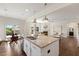Open-concept kitchen with granite countertops, stainless steel appliances, and a view of the living room at 833 Ember Dr, Durham, NC 27703