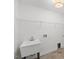 This laundry room features a utility sink, wire shelving, and tile floors at 833 Ember Dr, Durham, NC 27703
