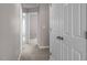 Hallway view shows multiple doors and neutral-colored walls leading to various rooms at 878 John St, Clayton, NC 27520