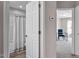 Hallway featuring white doors adjacent to the bathroom and bedroom with light-colored walls at 882 John St, Clayton, NC 27520