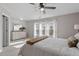 Bright main bedroom with ample natural light, plush carpet, and a ceiling fan at 886 John St, Clayton, NC 27520