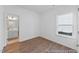 This bright bedroom features hard wood floors, a window, and an ensuite bathroom at 92 Horseshoe Pl # 9, Angier, NC 27501