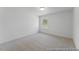 This carpeted bedroom features neutral paint and a large window at 92 Horseshoe Pl # 9, Angier, NC 27501