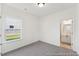 Bright bedroom with a window and doorway leading to a bathroom at 92 Horseshoe Pl # 9, Angier, NC 27501