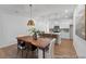 Dining room with modern lighting fixture and view to the open concept kitchen and breakfast bar at 92 Horseshoe Pl # 9, Angier, NC 27501