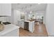 Open concept kitchen featuring stainless appliances, quartz countertops, and open view to the dining and living areas at 92 Horseshoe Pl # 9, Angier, NC 27501