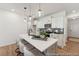Modern kitchen features an island with pendant lighting, sleek countertops, and stainless steel appliances at 92 Horseshoe Pl # 9, Angier, NC 27501