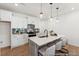 Modern kitchen features an island with seating, pendant lighting, sleek countertops, and stainless steel appliances at 92 Horseshoe Pl # 9, Angier, NC 27501