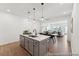 Open concept with a kitchen island, modern pendant lighting, dining, and living room at 92 Horseshoe Pl # 9, Angier, NC 27501