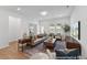 Well-lit living room with plush seating, hardwood floors, and a view to the outdoor patio at 92 Horseshoe Pl # 9, Angier, NC 27501