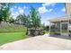 Backyard with a lawn, concrete patio and a hot tub surrounded by landscaping at 10 W Ravano Dr, Clayton, NC 27527