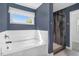 Modern bathroom with a soaking tub, shower, and bright natural light at 10 W Ravano Dr, Clayton, NC 27527