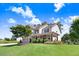Beautiful two-story home with a lush green lawn, stone-accented flower beds, and a welcoming covered porch at 10 W Ravano Dr, Clayton, NC 27527