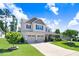 Stunning two-story home boasts a manicured lawn, two-car garage, and cozy covered porch adorned with flowers at 10 W Ravano Dr, Clayton, NC 27527
