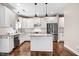 Modern kitchen with white cabinets, granite countertops, stainless steel appliances, and a center island at 10 W Ravano Dr, Clayton, NC 27527