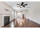 Bright living room showcasing hardwood floors, fireplace, and an open layout to the kitchen at 10 W Ravano Dr, Clayton, NC 27527