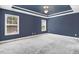 Spacious main bedroom with tray ceiling, fan, and large windows at 10 W Ravano Dr, Clayton, NC 27527