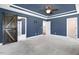 Large main bedroom with doors, modern ceiling fan, and carpet flooring at 10 W Ravano Dr, Clayton, NC 27527