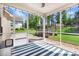 Covered patio with a blue striped rug and a view of the lawn and hot tub at 10 W Ravano Dr, Clayton, NC 27527