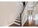 Elegant staircase with hardwood treads and white risers leads upstairs at 10 W Ravano Dr, Clayton, NC 27527