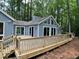Beautiful back exterior of the house with wooden deck and glass doors at 102 Pebble Ct, Chapel Hill, NC 27516