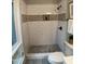 Bathroom featuring a walk-in shower, white subway tile, mosaic accents, and stone floor at 102 Pebble Ct, Chapel Hill, NC 27516