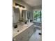Bright bathroom with double sinks, quartz countertops, black fixtures, and stylish tile floors at 102 Pebble Ct, Chapel Hill, NC 27516