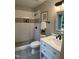 Nicely remodeled bathroom featuring a tile shower with mosaic accents, white vanity and large window at 102 Pebble Ct, Chapel Hill, NC 27516