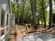 New wooden deck with black railings, surrounded by trees and gravel at 102 Pebble Ct, Chapel Hill, NC 27516