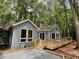 Attractive one-story home with modern deck surrounded by trees and well maintained landscaping at 102 Pebble Ct, Chapel Hill, NC 27516