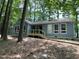 Exterior view of a house with a wooden deck nestled in a serene, wooded setting at 102 Pebble Ct, Chapel Hill, NC 27516