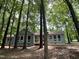 One-story home nestled among mature trees, featuring a new deck for outdoor enjoyment at 102 Pebble Ct, Chapel Hill, NC 27516
