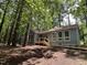 Charming one-story home with blue siding surrounded by lush greenery and mature trees at 102 Pebble Ct, Chapel Hill, NC 27516