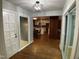 Hallway leading to kitchen and dining room with hardwood floors and natural light at 102 Pebble Ct, Chapel Hill, NC 27516
